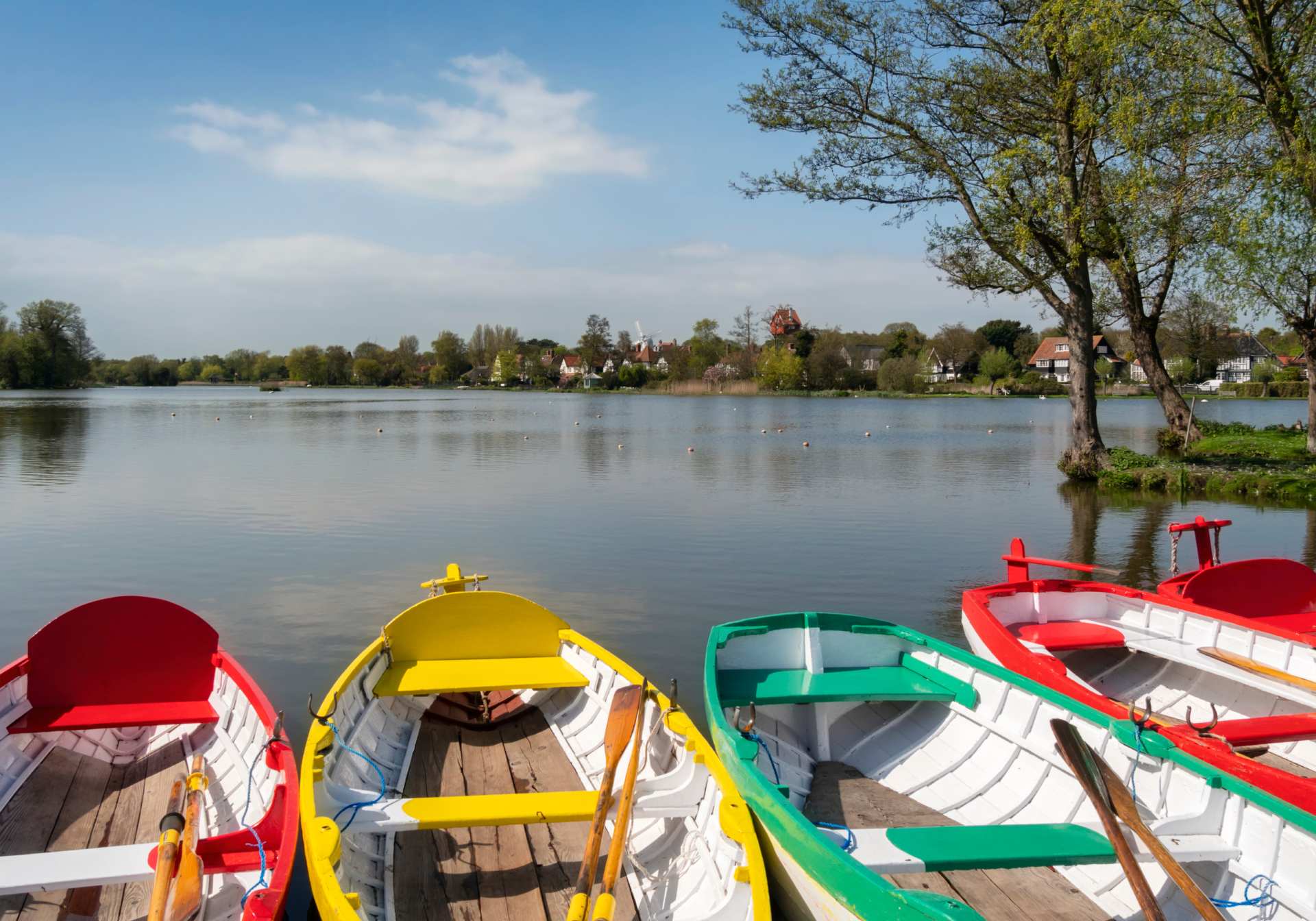 Colourful rowing boats on Thorpeness Meare in Suffolk